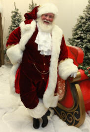 Dark red suit with open coat, vest, and jabot.